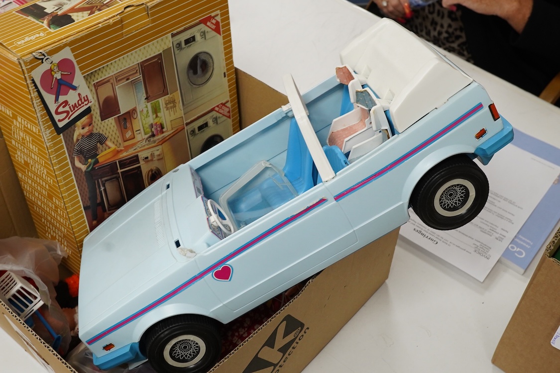 A collection of boxed Sindy doll furniture and accessories, including; a motorcycle (44384), a writing bureau (44512), a hostess trolley, a dressing table, a camping scene, a washing machine unit, together with boxed ite